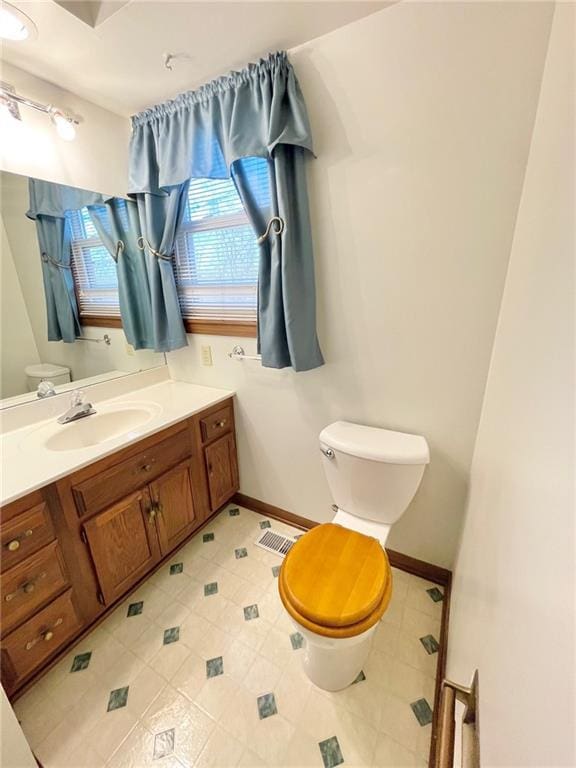 bathroom featuring vanity and toilet