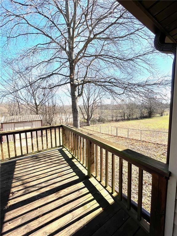 wooden terrace featuring a rural view