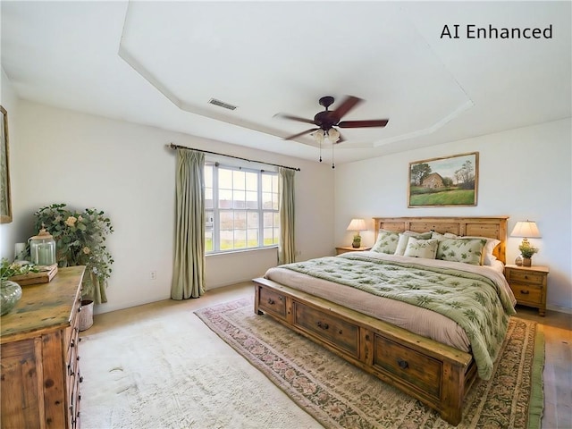 bedroom with ceiling fan, a raised ceiling, and light colored carpet