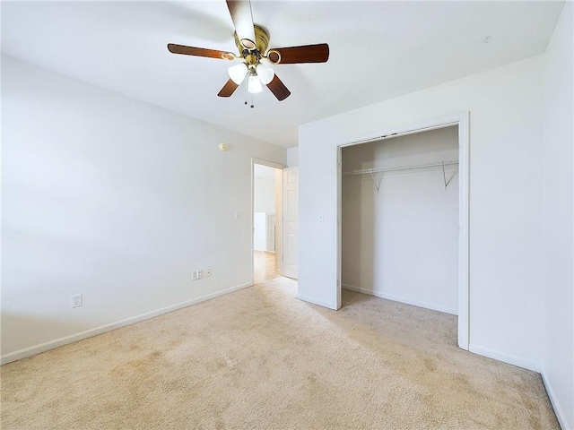 unfurnished bedroom featuring light colored carpet, a closet, and ceiling fan