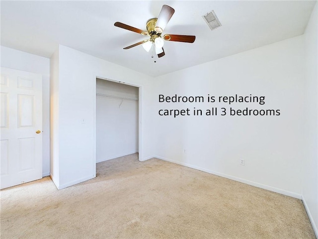 unfurnished bedroom featuring ceiling fan, a closet, and light carpet