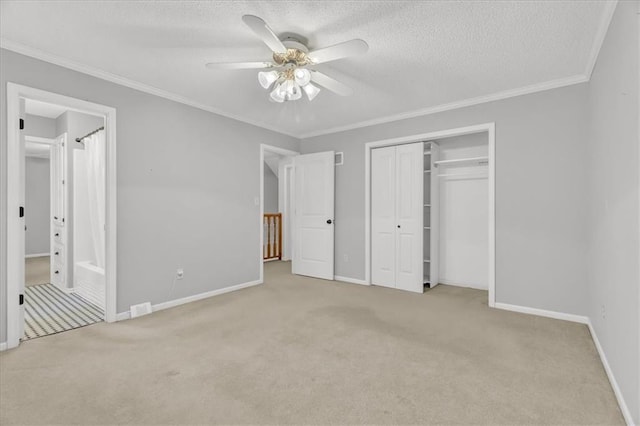 unfurnished bedroom with a textured ceiling, ceiling fan, crown molding, and light carpet