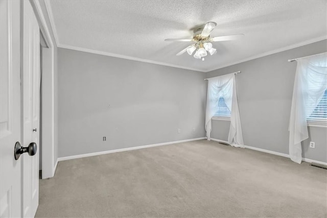 unfurnished bedroom featuring ceiling fan, light colored carpet, a textured ceiling, and multiple windows