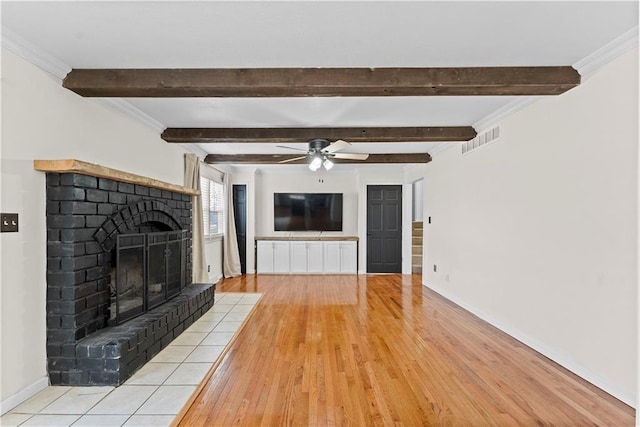 unfurnished living room featuring ceiling fan, crown molding, a fireplace, and light hardwood / wood-style flooring