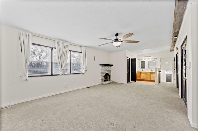 unfurnished living room featuring ceiling fan, a fireplace, and light carpet