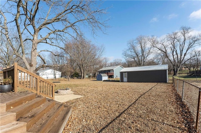 view of yard featuring an outbuilding and a wooden deck