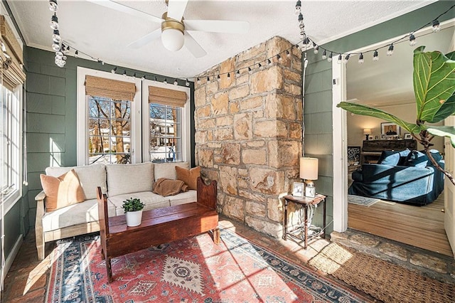 sitting room featuring ceiling fan, crown molding, and a textured ceiling