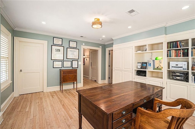 home office with light wood-type flooring and crown molding