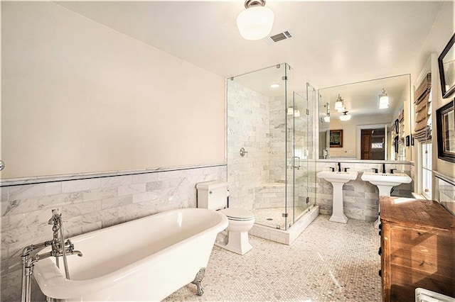 full bathroom featuring sink, tile patterned flooring, tile walls, toilet, and independent shower and bath