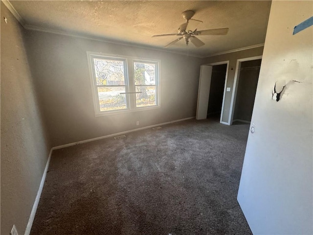 carpeted empty room with a textured ceiling, ceiling fan, and ornamental molding