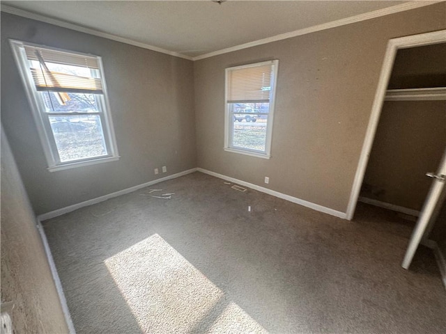 unfurnished bedroom with carpet flooring, crown molding, and a closet