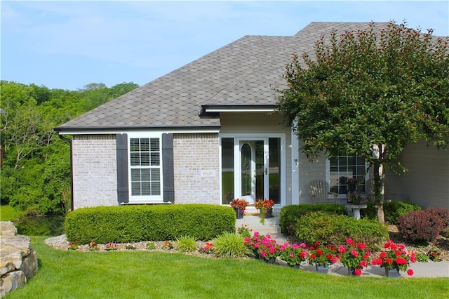 exterior space with a front yard and brick siding