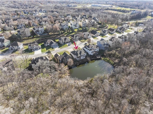 birds eye view of property featuring a water view and a residential view