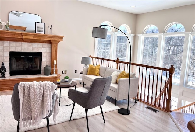 sitting room with light wood finished floors, plenty of natural light, and visible vents