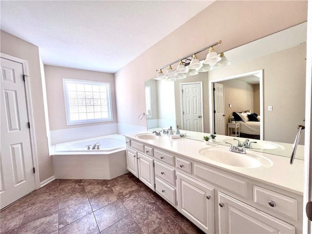 full bath with double vanity, a garden tub, a sink, and ensuite bathroom