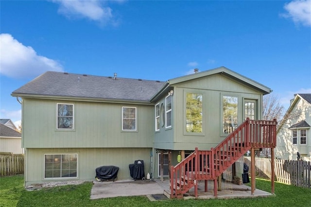 rear view of house featuring a lawn and a patio area