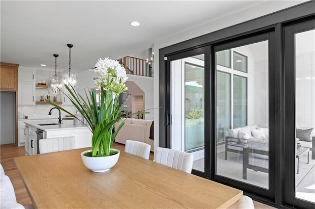 dining space featuring light wood finished floors and recessed lighting