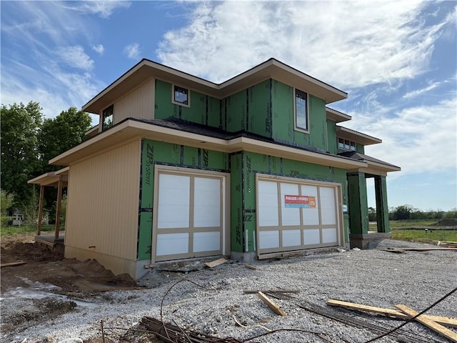 back of property with an attached garage