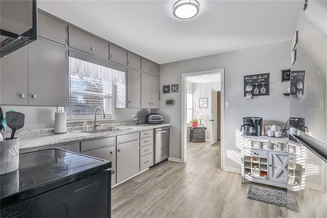 kitchen with gray cabinetry, electric range, sink, stainless steel dishwasher, and light hardwood / wood-style floors