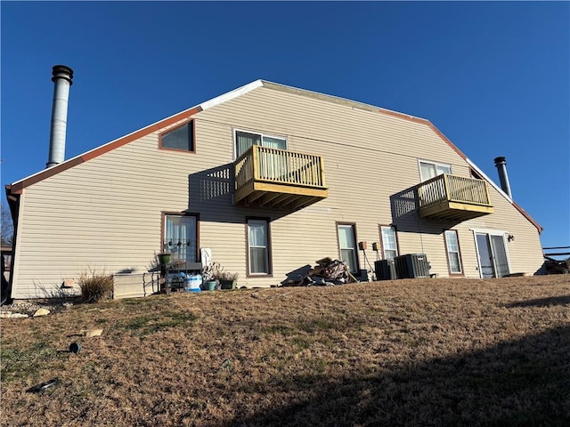 rear view of property with a balcony and cooling unit