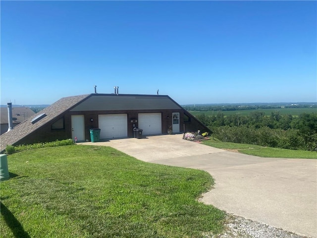 view of front of property featuring a garage and a front lawn