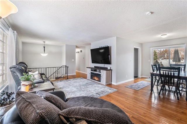 living room featuring a textured ceiling and hardwood / wood-style floors