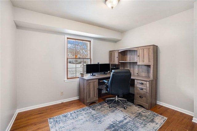 office with dark hardwood / wood-style floors