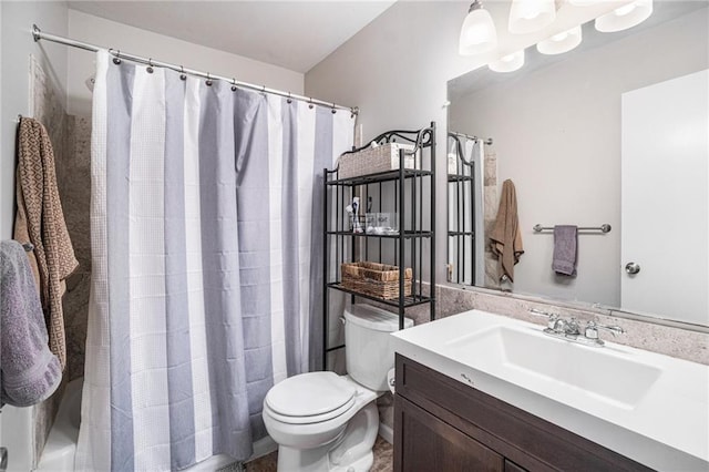 bathroom featuring toilet, walk in shower, and vanity