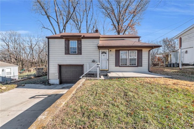 view of front of property with a garage and a front lawn