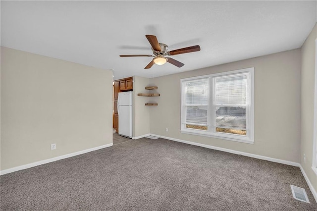 empty room with ceiling fan and light colored carpet