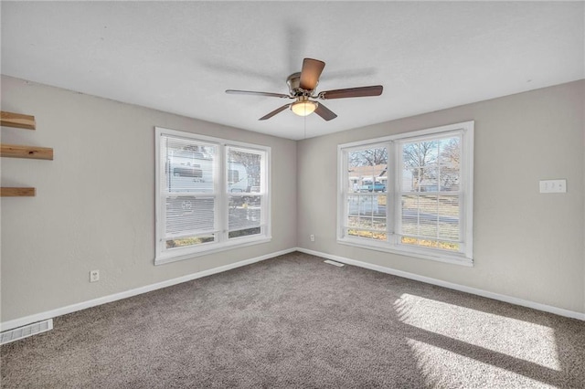 carpeted empty room featuring ceiling fan