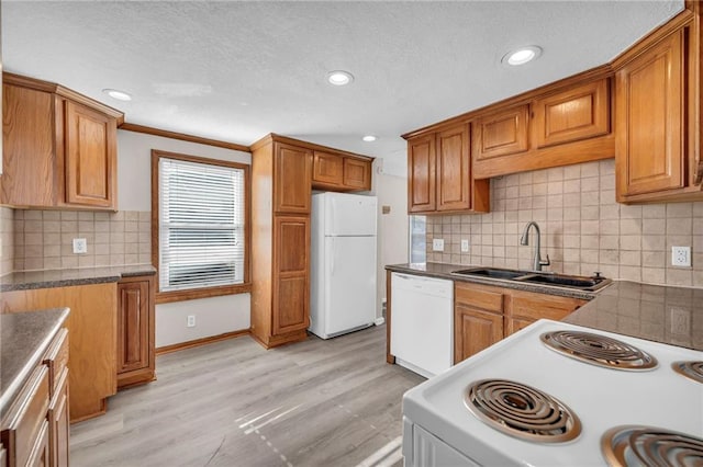 kitchen featuring ornamental molding, white appliances, sink, and light hardwood / wood-style flooring