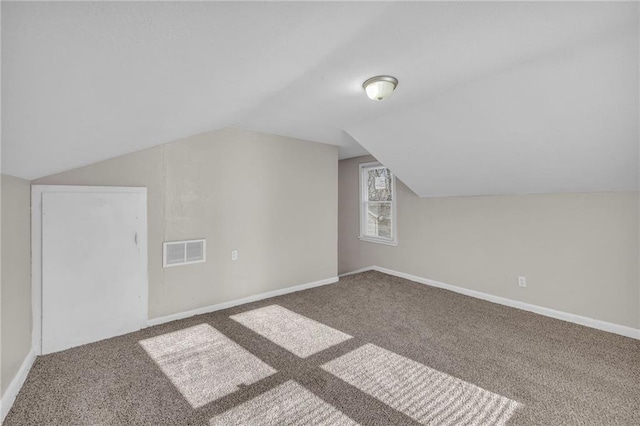 additional living space featuring lofted ceiling and carpet floors