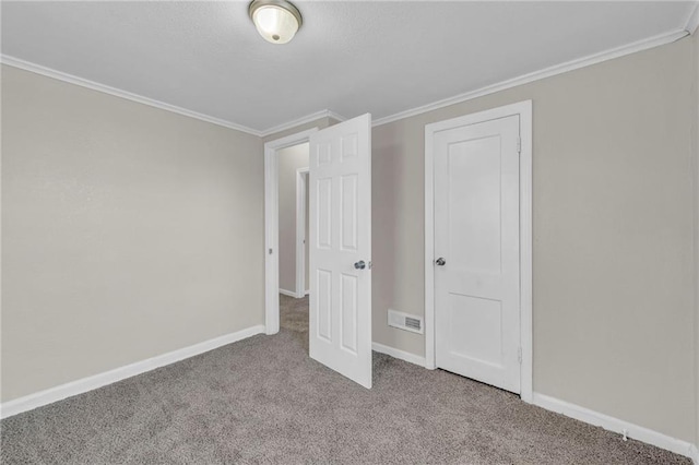 unfurnished bedroom featuring light colored carpet and ornamental molding