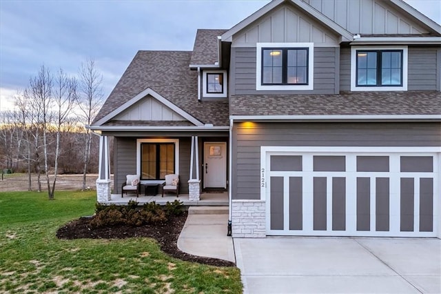 craftsman inspired home featuring a front lawn, covered porch, and a garage