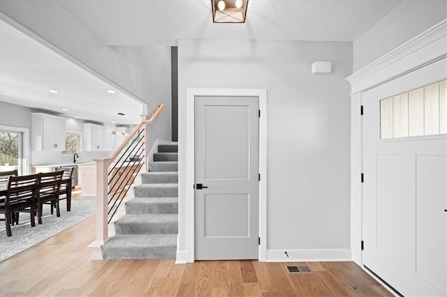 stairway with hardwood / wood-style flooring