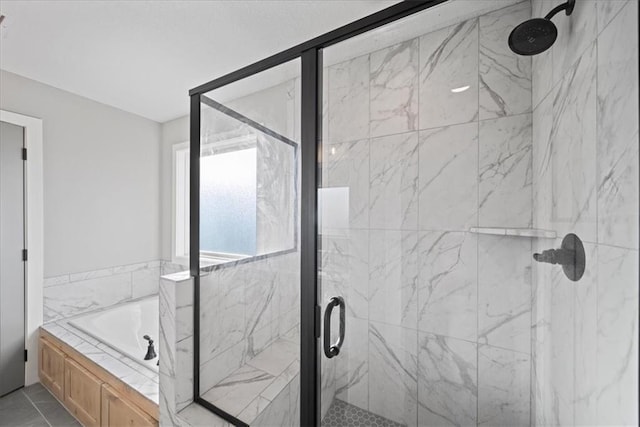 bathroom featuring tile patterned flooring and independent shower and bath