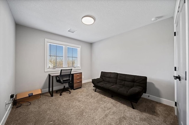 carpeted office with a textured ceiling