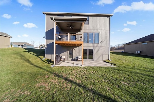 rear view of property with a lawn, a patio area, ceiling fan, and a balcony