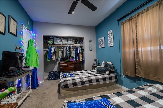 carpeted bedroom featuring ceiling fan and a closet