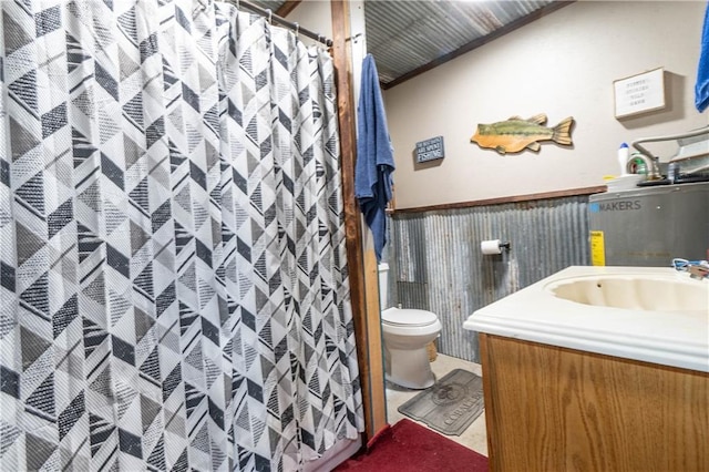 bathroom featuring vanity, gas water heater, and toilet