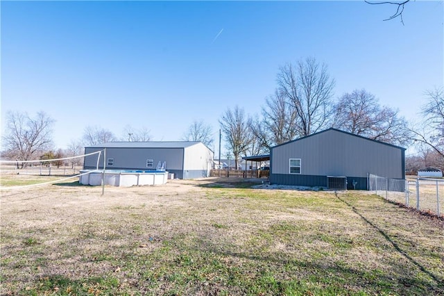 view of yard with a fenced in pool and central AC unit