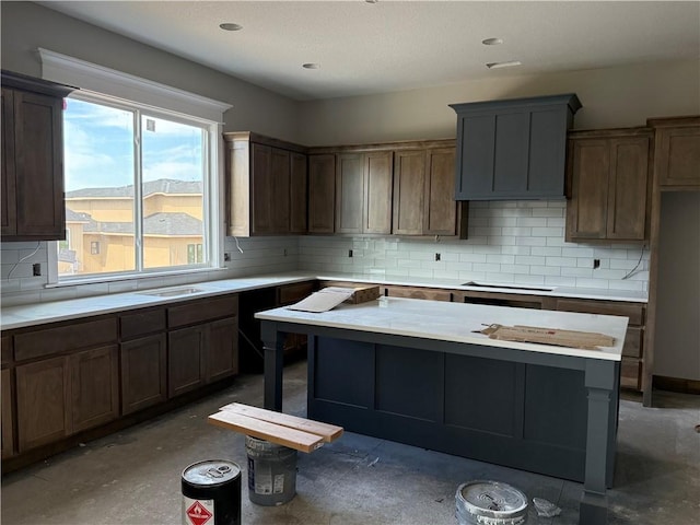 12404 W 184th St, Overland Park, KS 66013 - kitchen with light countertops, backsplash, concrete floors, and a center island