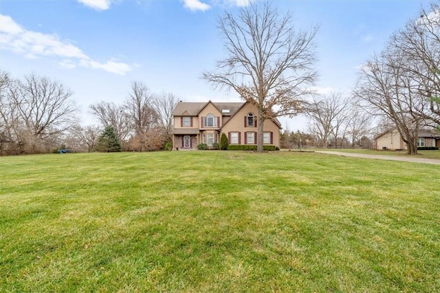 tudor-style house featuring a front yard