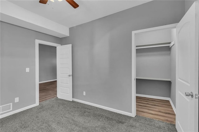 unfurnished bedroom with hardwood / wood-style floors, a closet, and ceiling fan