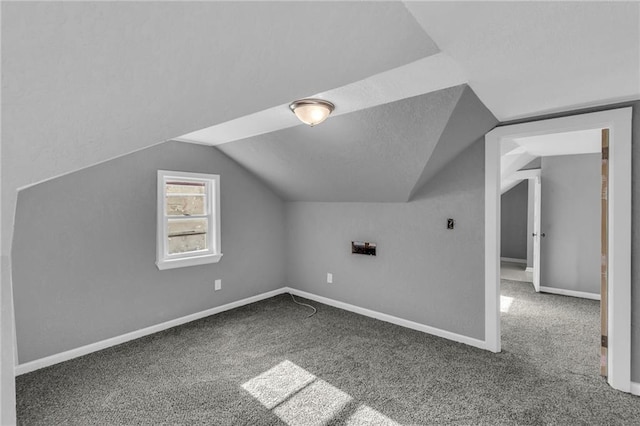 additional living space with carpet floors and lofted ceiling