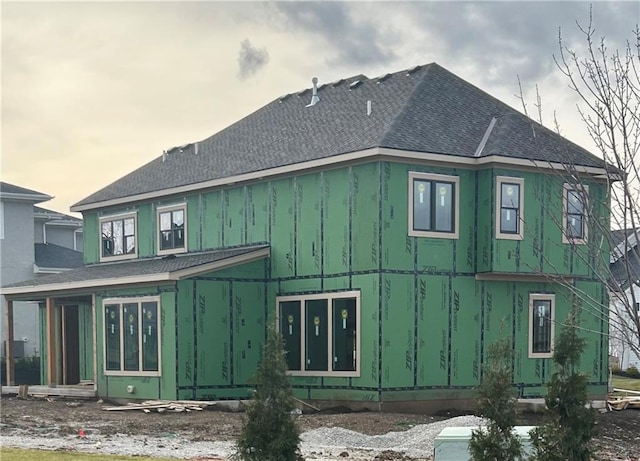 17021 King St, Overland Park, KS 66221 - view of home's exterior with board and batten siding and a shingled roof