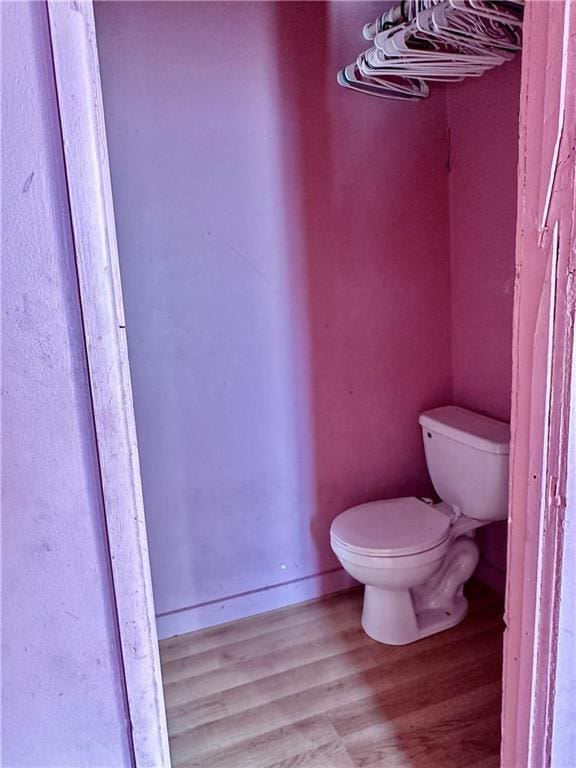 bathroom featuring hardwood / wood-style floors and toilet