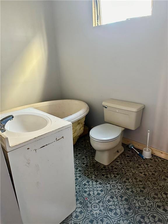 bathroom featuring tile patterned flooring, vanity, and toilet