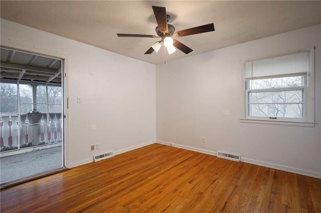 empty room featuring hardwood / wood-style flooring and ceiling fan